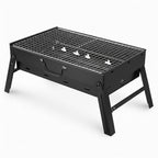 Black portable grill on a white background