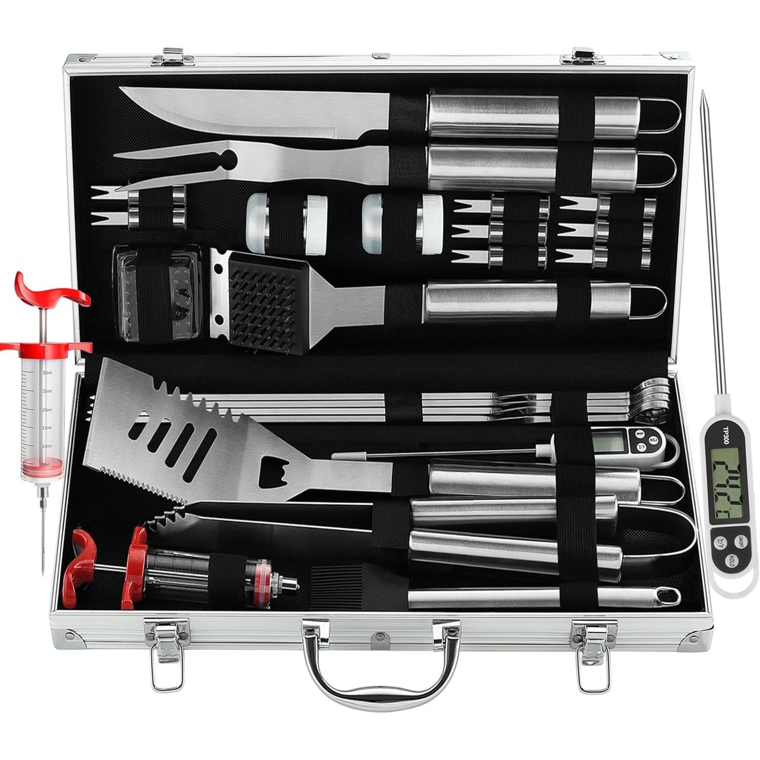 Set of barbecue tools in a metallic case with a digital thermometer on a white background