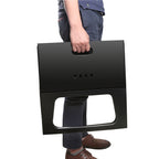 Person holding a black folding stool against a white background