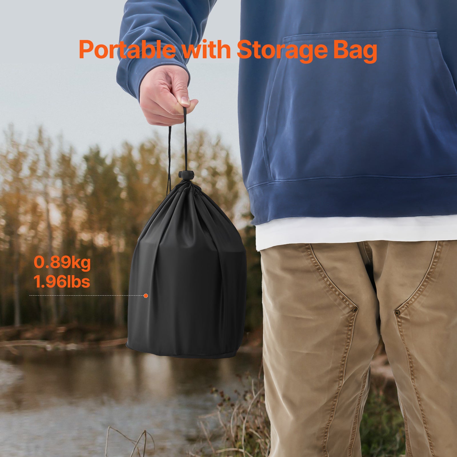 Person holding a black drawstring bag with text indicating weight and 'Portable with Storage Bag' feature, outdoors.